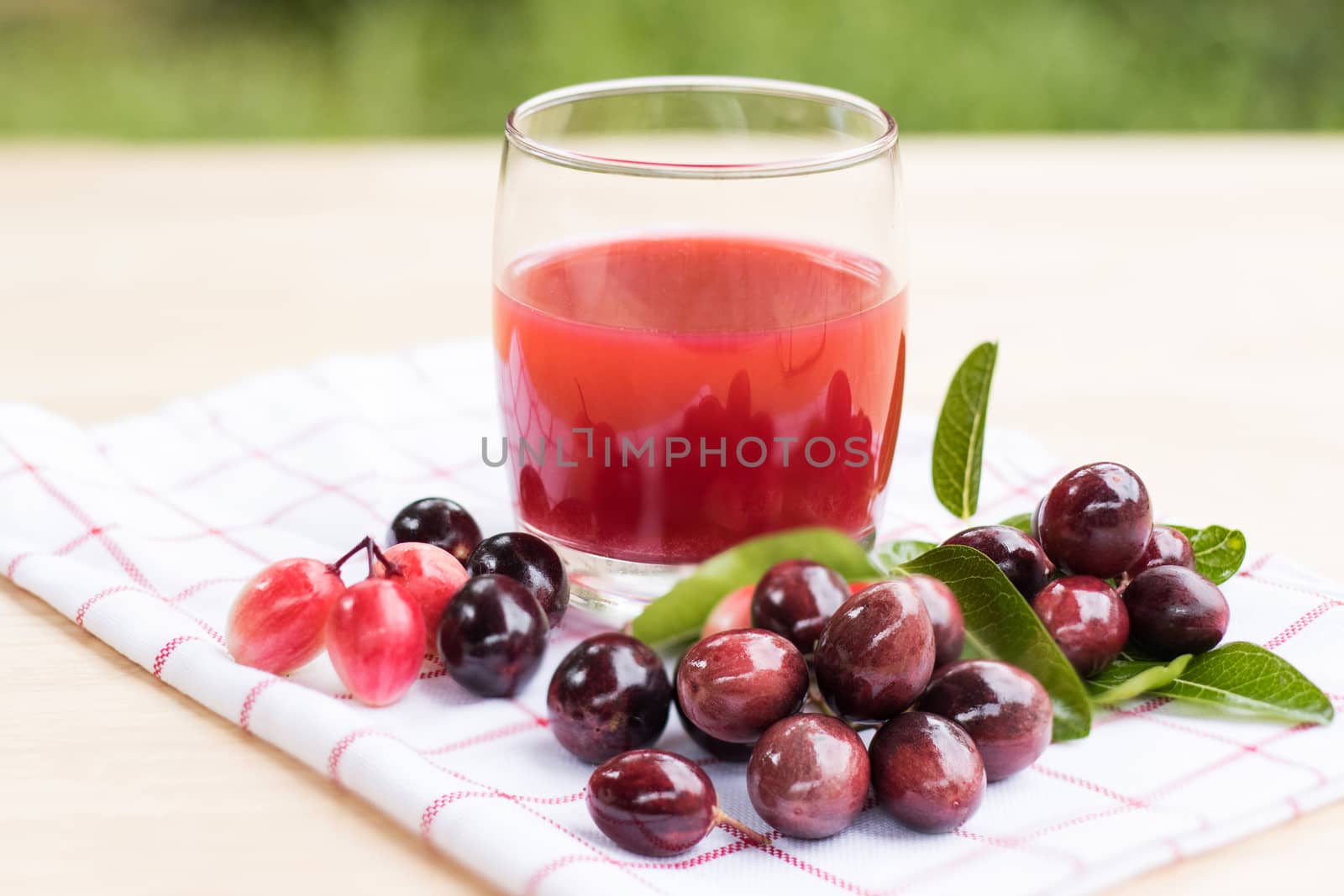 fresh Carissa carandas glass of juice with Carissa carandas fruits and Healthy drinks concept