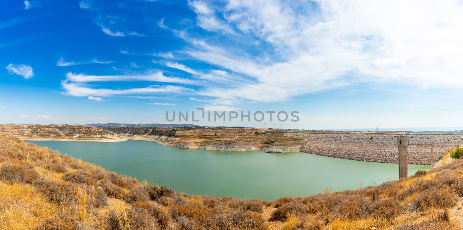 Asprokremmos reservoir fresh water lake panorama with blue sky, Paphos district, Cypros
