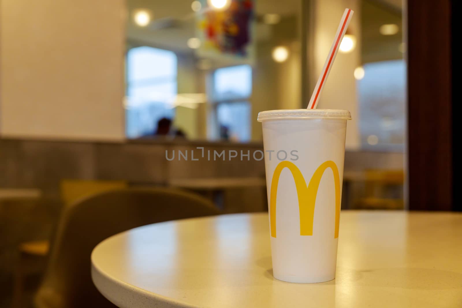 NewYork NY NOV 07 2019: Cup of McDonald's Cola in the background of the McDonald's restaurant. McDonald's Corporation is the restaurants.