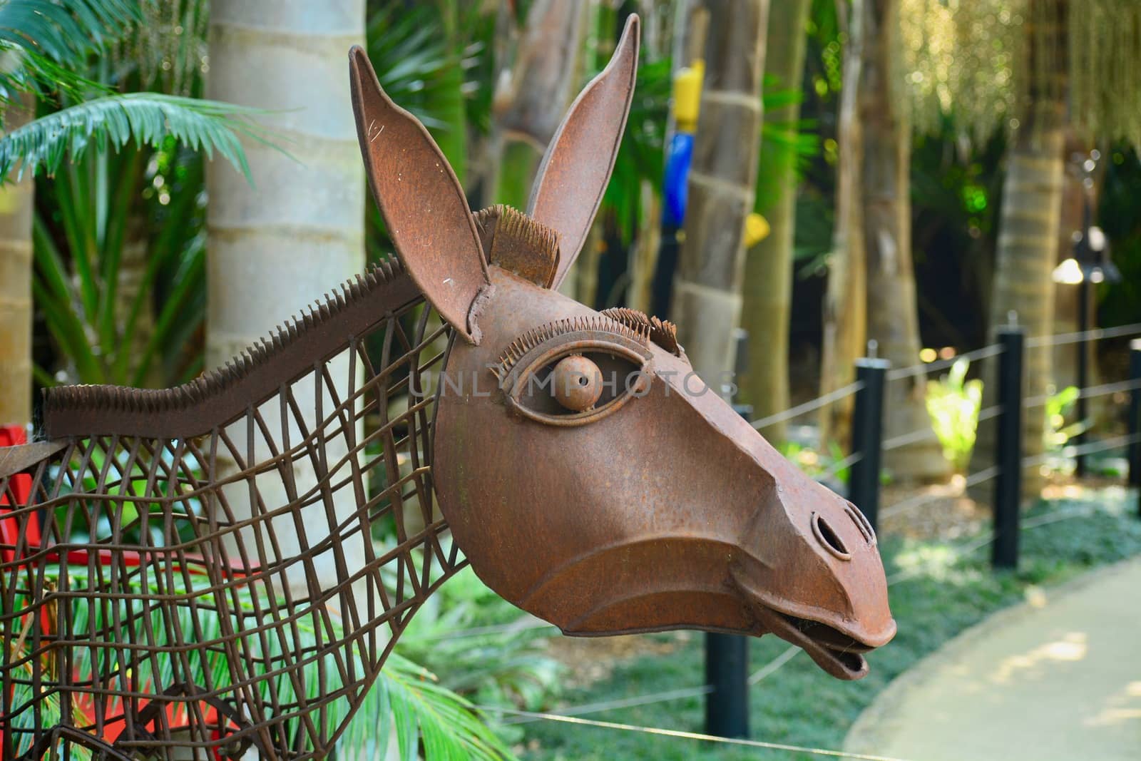 Peculiar modern sculpture made of rusty wire and some metal parts, representing a donkey.