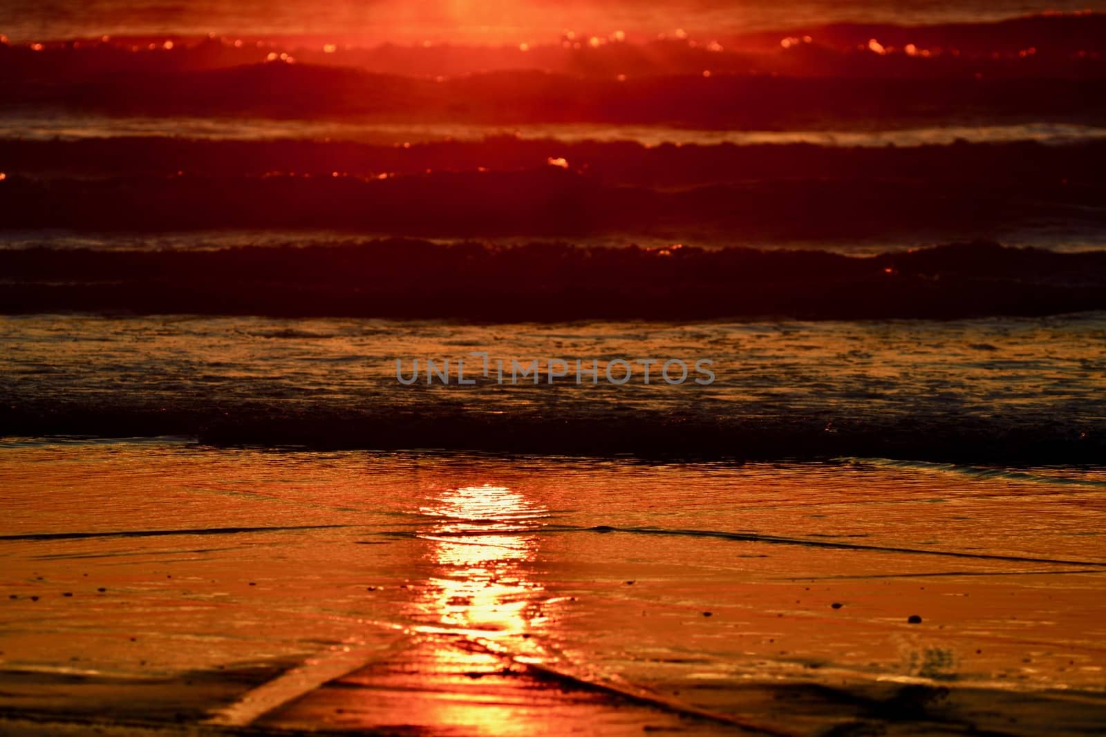 Dramatic sunset colours; beautiful sunset on a beach. Sun reflection in the water. by Marshalkina