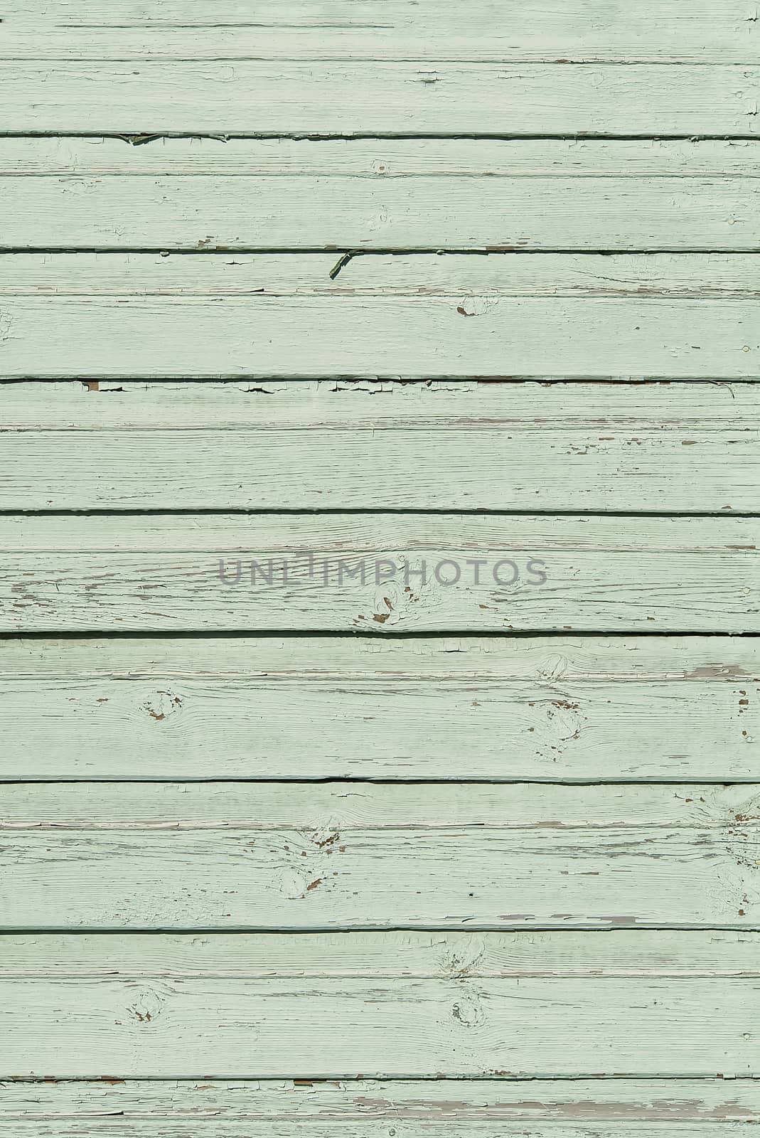 The texture of old scratched green wooden planks. Old painted wood wall texture
