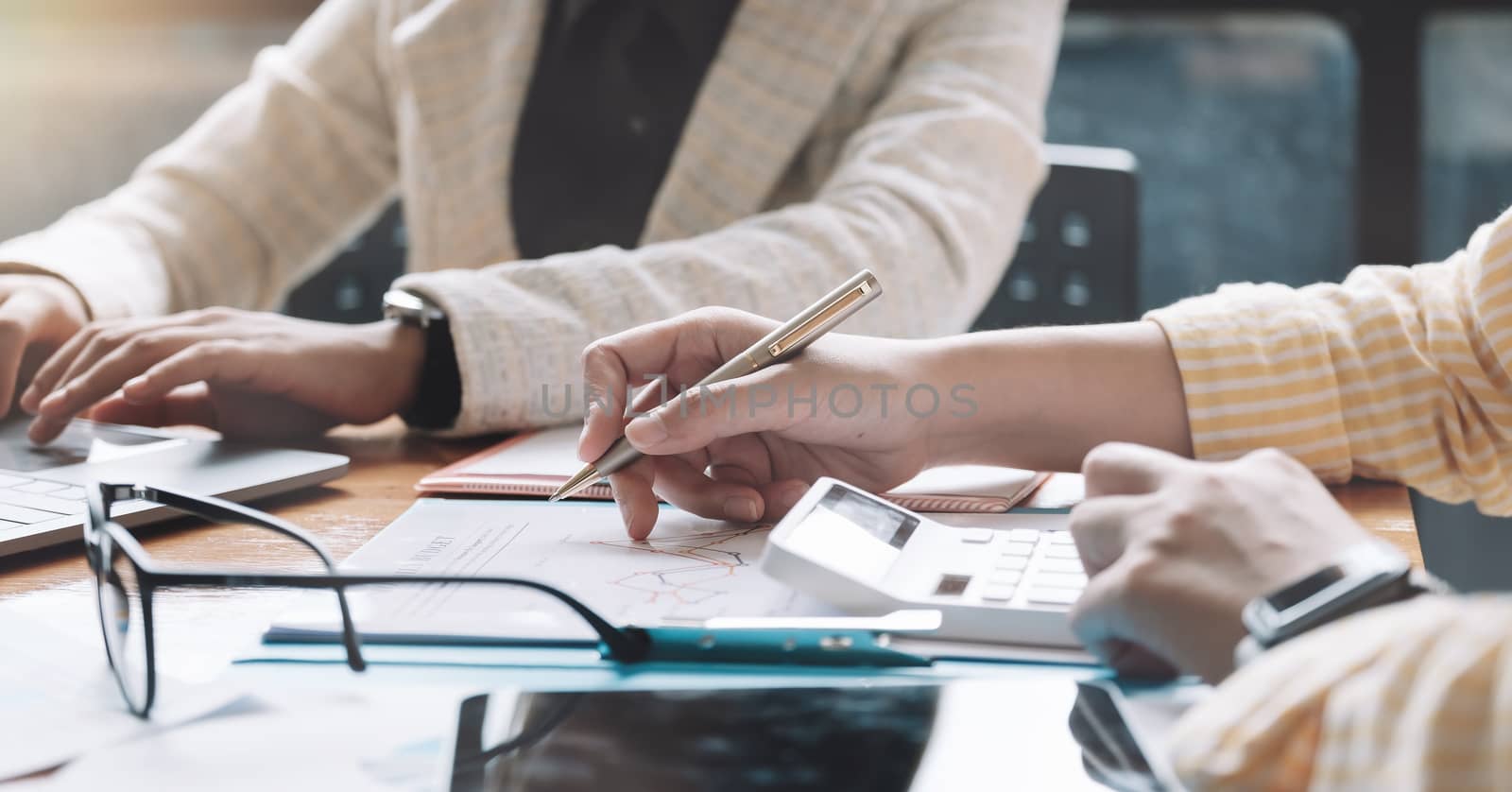 Business colleagues working or meeting with partner discussing financial documents and idea.