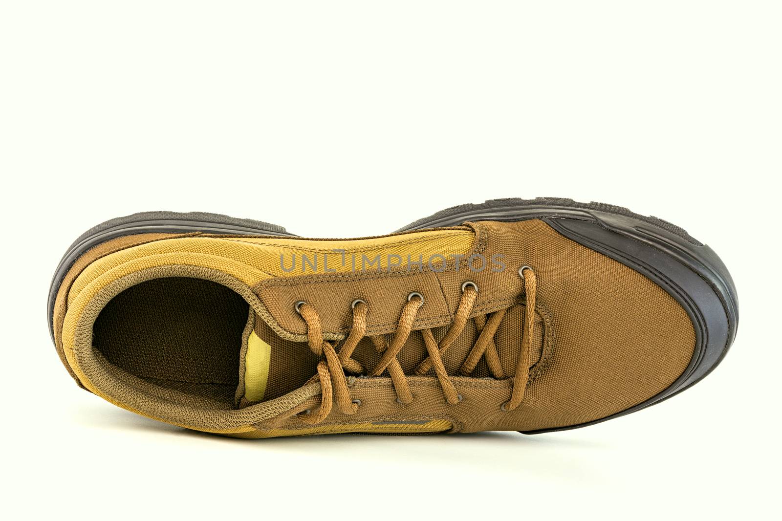 one right cheap yellow fabric hiking shoe isolated on white background.