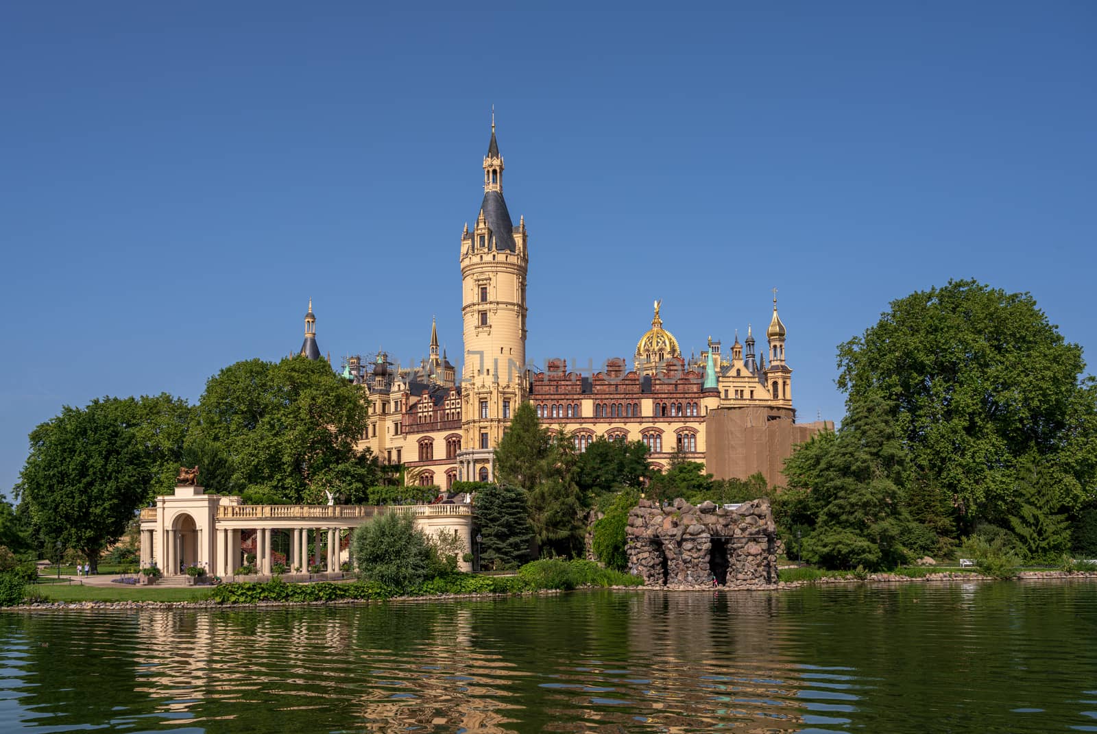 A side angle view of Schwerin Palace and its gardens.