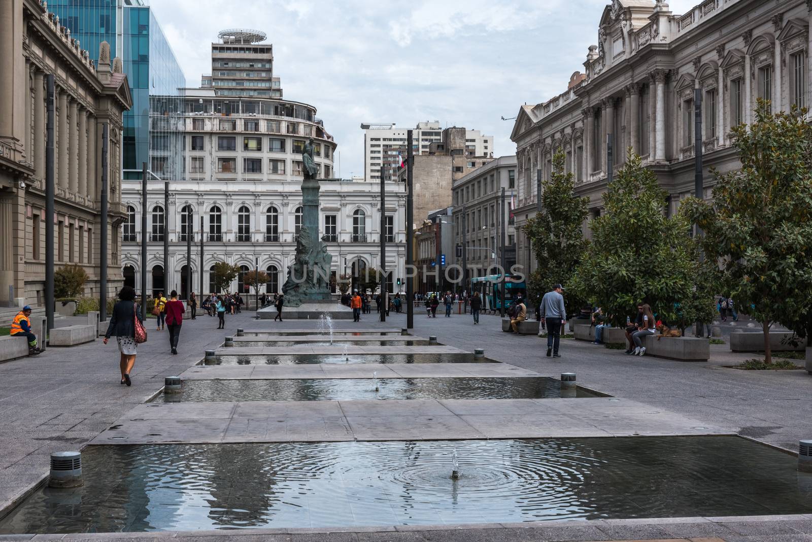 Santiago, Chile--April 6, 2018.  People are walking along wide open plaza with classical architecture on a street in Santiago, Chile.