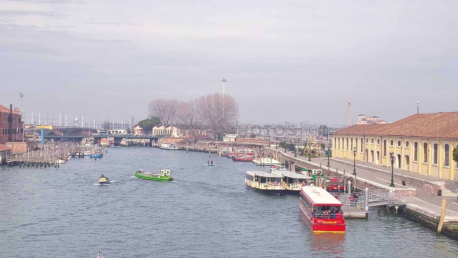 Venice, Italy - 04/24/2019: Foggy (misty) Venice. Canal (channel), historical, old houses and gondoliers with gondolas in thick fog. Scenic cityscape view. Venice. Italy. Copy space. Empty place for message. Outdoor.