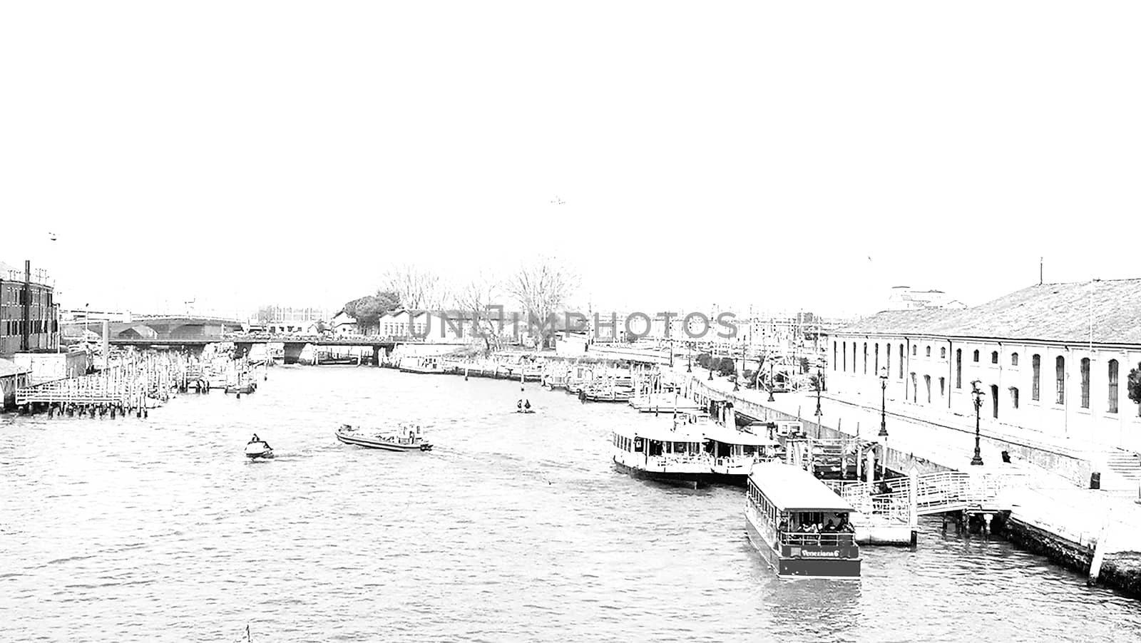 Venice, Italy - 04/24/2019: Foggy (misty) Venice. Canal (channel), historical, old houses and gondoliers with gondolas in thick fog. Scenic cityscape view. Venice. Italy. Copy space. Empty place for message. Outdoor.