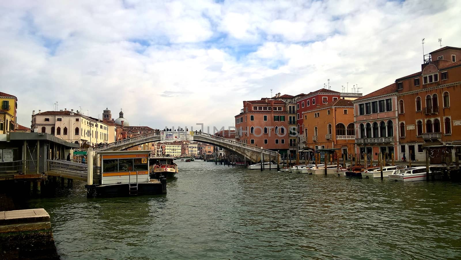 Venice, Italy - 04/24/2019: Foggy (misty) Venice. Canal (channel), historical, old houses and gondoliers with gondolas in thick fog. Scenic cityscape view. Venice. Italy. Copy space. Empty place for message. Outdoor.