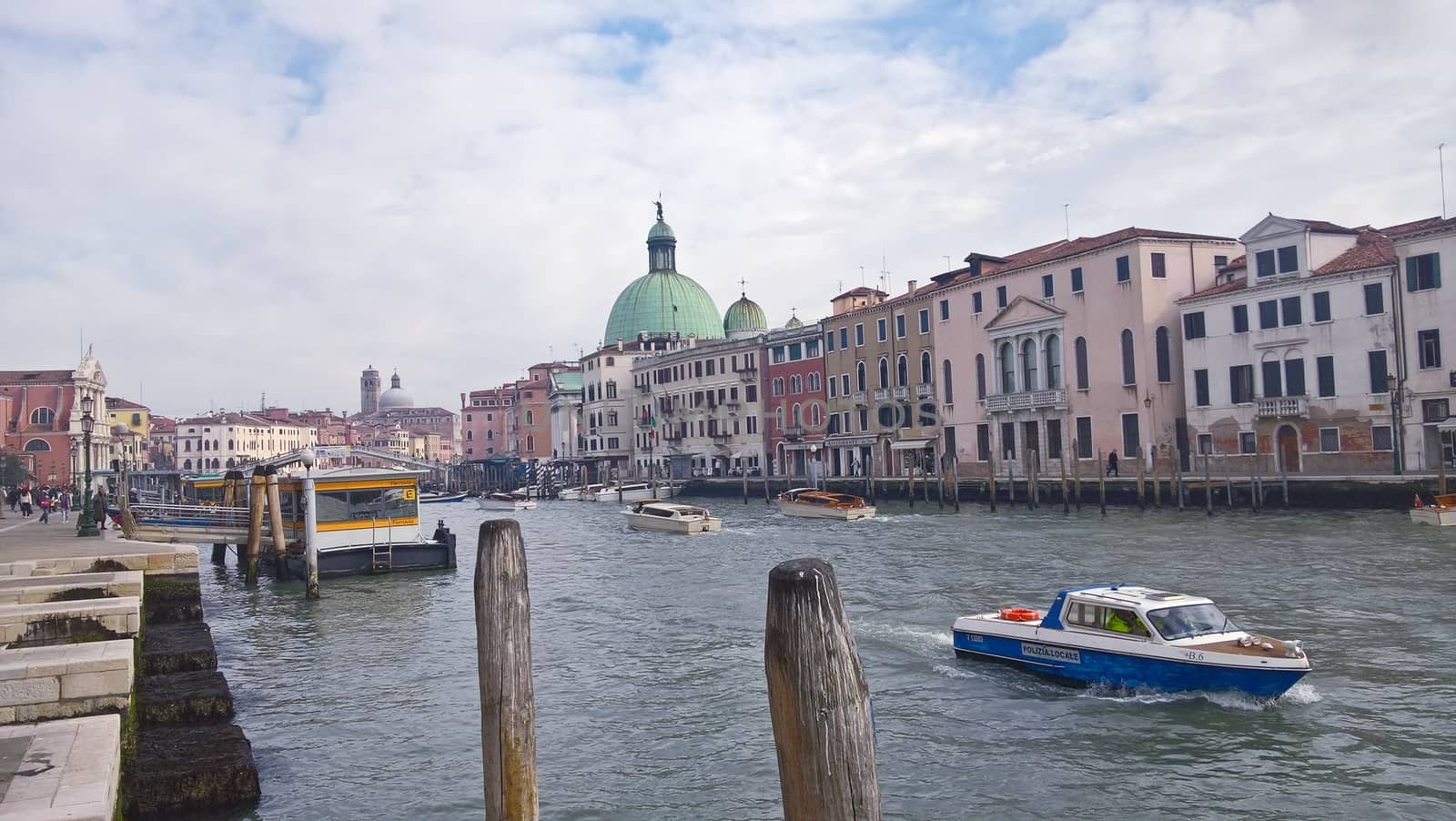 Venice, Italy - 04/24/2019: Foggy (misty) Venice. Canal (channel), historical, old houses and gondoliers with gondolas in thick fog. Scenic cityscape view. Venice. Italy. Copy space. Empty place for message. Outdoor.