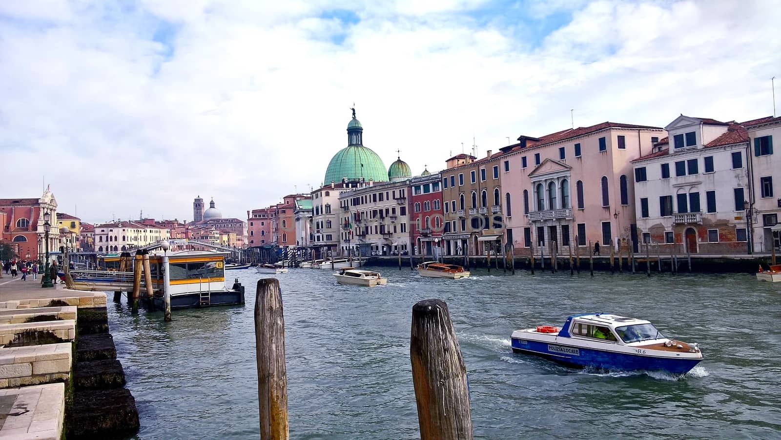 Venice, Italy - 04/24/2019: Foggy (misty) Venice. Canal (channel), historical, old houses and gondoliers with gondolas in thick fog. Scenic cityscape view. Venice. Italy. Copy space. Empty place for message. Outdoor.