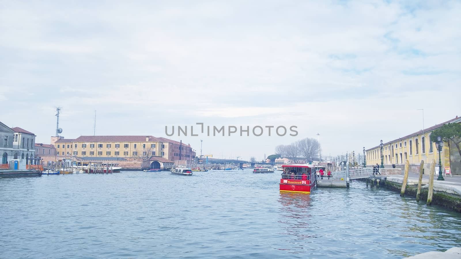 Venice, Italy - 04/24/2019: Foggy (misty) Venice. Canal (channel), historical, old houses and gondoliers with gondolas in thick fog. Scenic cityscape view. Venice. Italy. Copy space. Empty place for message. Outdoor.