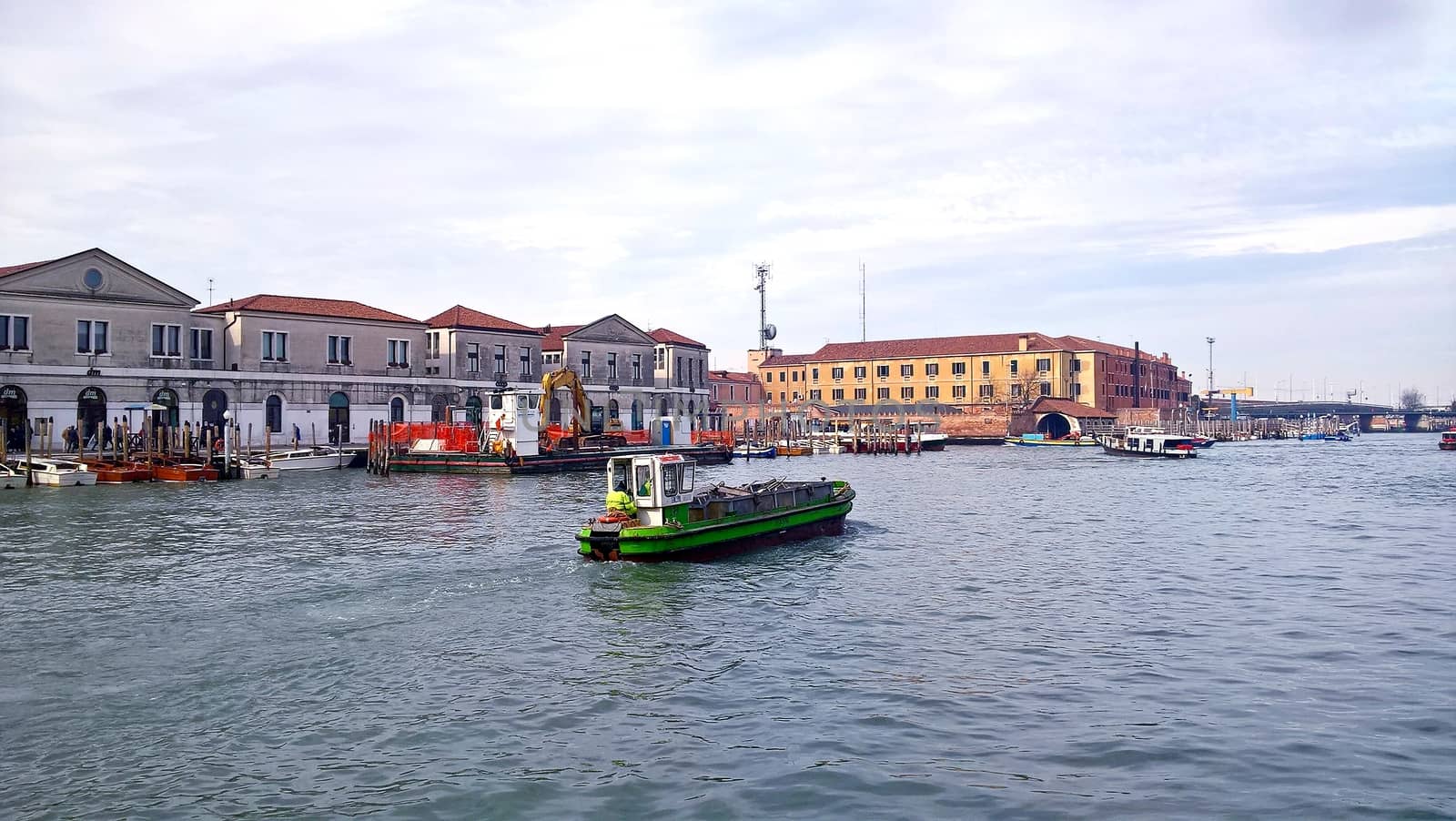 Venice, Italy - 04/24/2019: Foggy (misty) Venice. Canal (channel), historical, old houses and gondoliers with gondolas in thick fog. Scenic cityscape view. Venice. Italy. Copy space. Empty place for message. Outdoor.