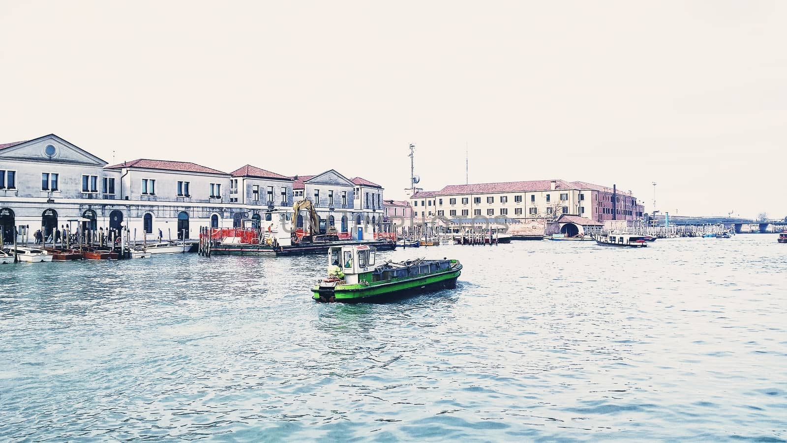 Venice, Italy - 04/24/2019: Foggy (misty) Venice. Canal (channel), historical, old houses and gondoliers with gondolas in thick fog. Scenic cityscape view. Venice. Italy. Copy space. Empty place for message. Outdoor.