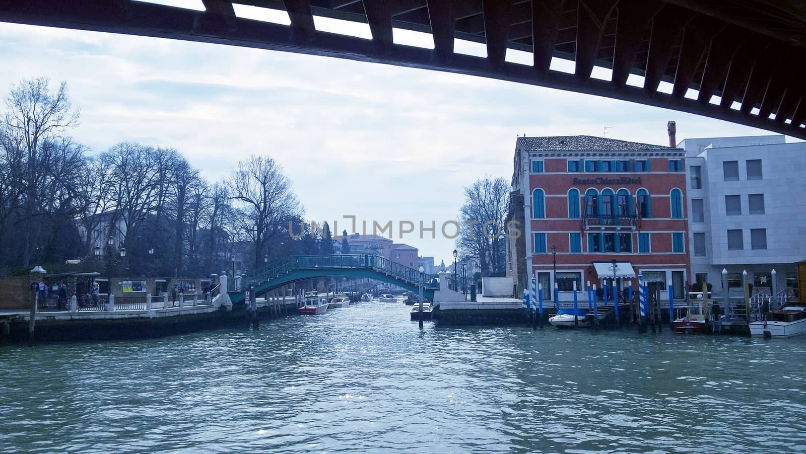 Venice, Italy - 04/24/2019: Foggy (misty) Venice. Canal (channel), historical, old houses and gondoliers with gondolas in thick fog. Scenic cityscape view. Venice. Italy. Copy space. Empty place for message. Outdoor.