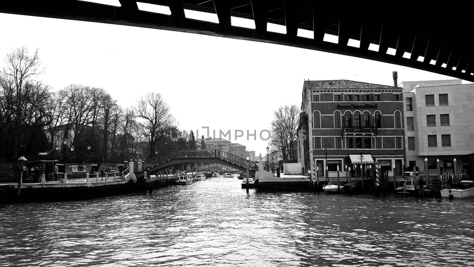 Venice, Italy - 04/24/2019: Foggy (misty) Venice. Canal (channel), historical, old houses and gondoliers with gondolas in thick fog. Scenic cityscape view. Venice. Italy. Copy space. Empty place for message. Outdoor.