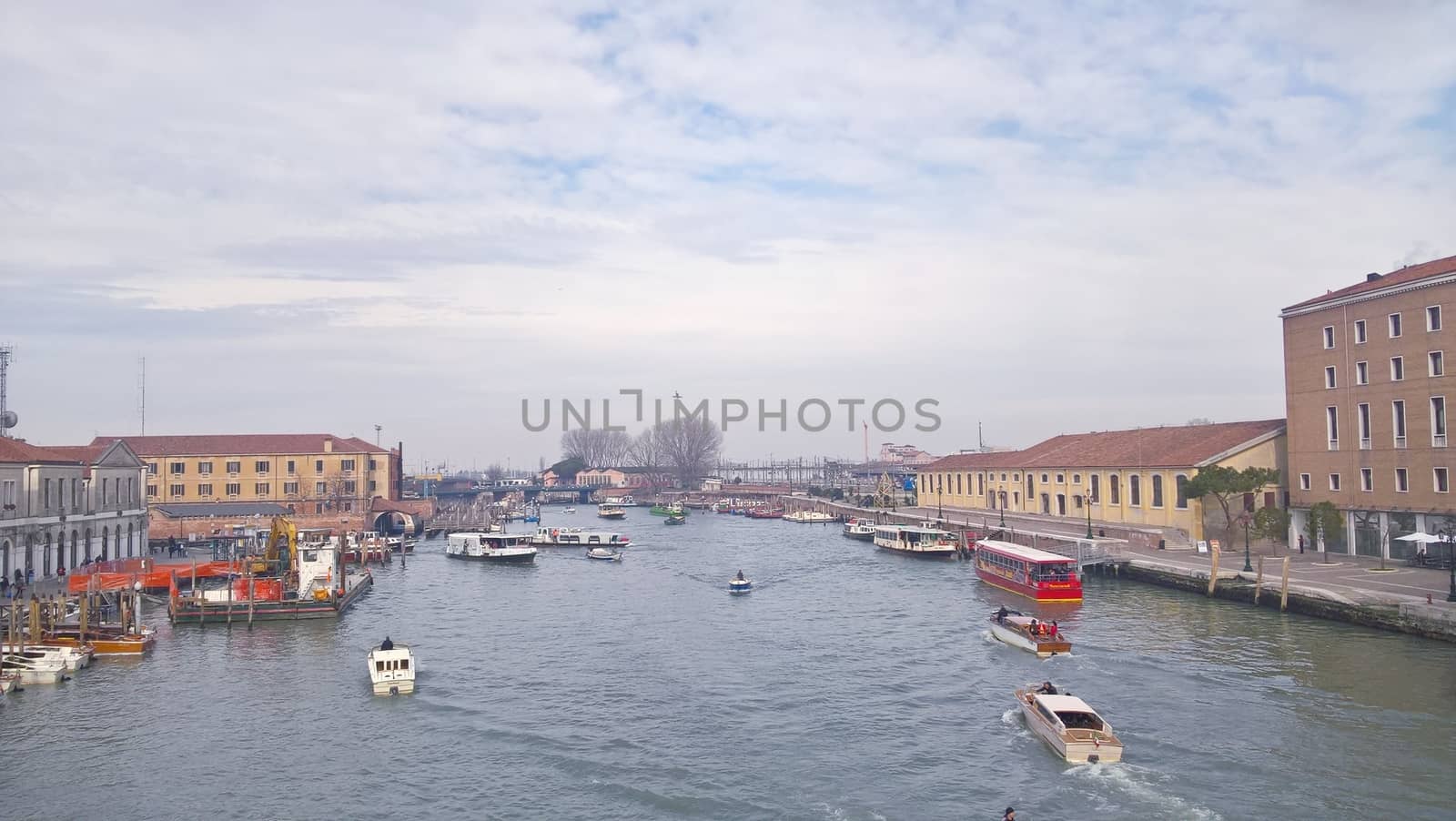 Venice, Italy - 04/24/2019: Foggy (misty) Venice. Canal (channel), historical, old houses and gondoliers with gondolas in thick fog. Scenic cityscape view. Venice. Italy. Copy space. Empty place for message. Outdoor.