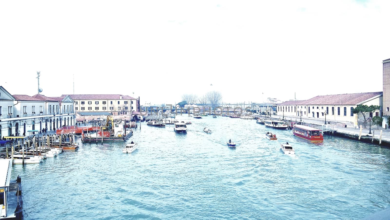 Venice, Italy - 04/24/2019: Foggy (misty) Venice. Canal (channel), historical, old houses and gondoliers with gondolas in thick fog. Scenic cityscape view. Venice. Italy. Copy space. Empty place for message. Outdoor.