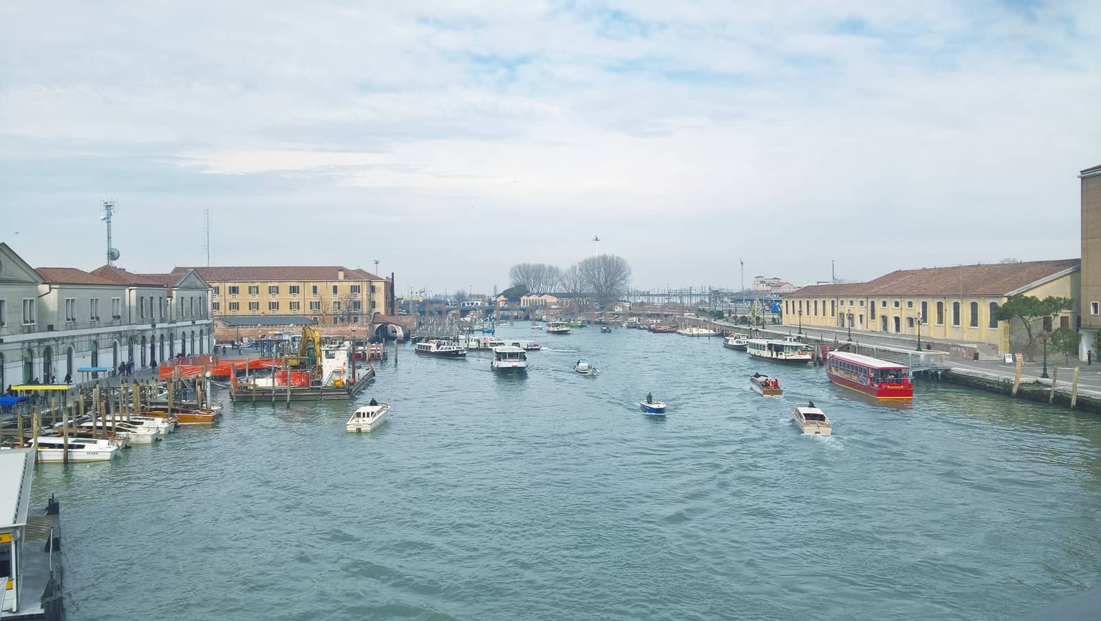 Venice, Italy - 04/24/2019: Foggy (misty) Venice. Canal (channel), historical, old houses and gondoliers with gondolas in thick fog. Scenic cityscape view. Venice. Italy. Copy space. Empty place for message. Outdoor.