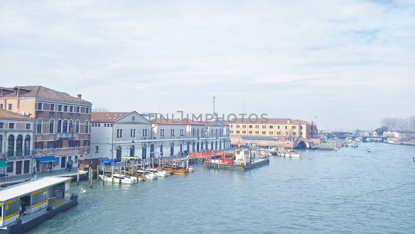 Venice, Italy - 04/24/2019: Foggy (misty) Venice. Canal (channel), historical, old houses and gondoliers with gondolas in thick fog. Scenic cityscape view. Venice. Italy. Copy space. Empty place for message. Outdoor.