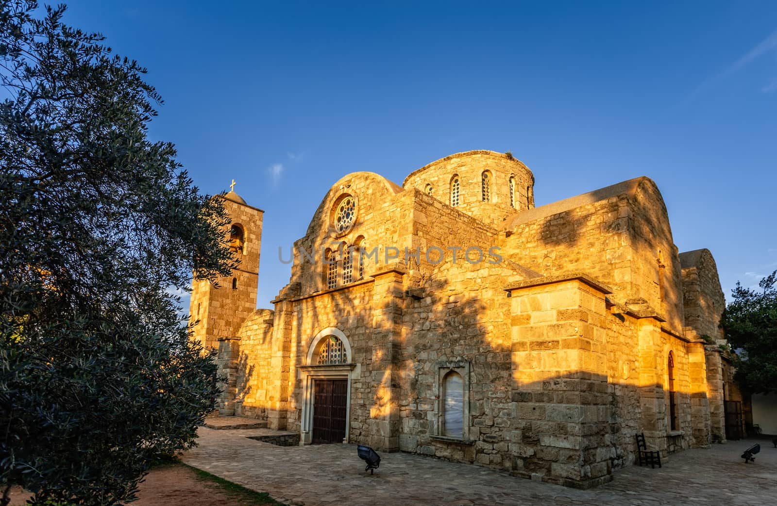 Saint apostle Barnabas monastery and the bell tower in sunset rays, near Famagusta, North Cyprus