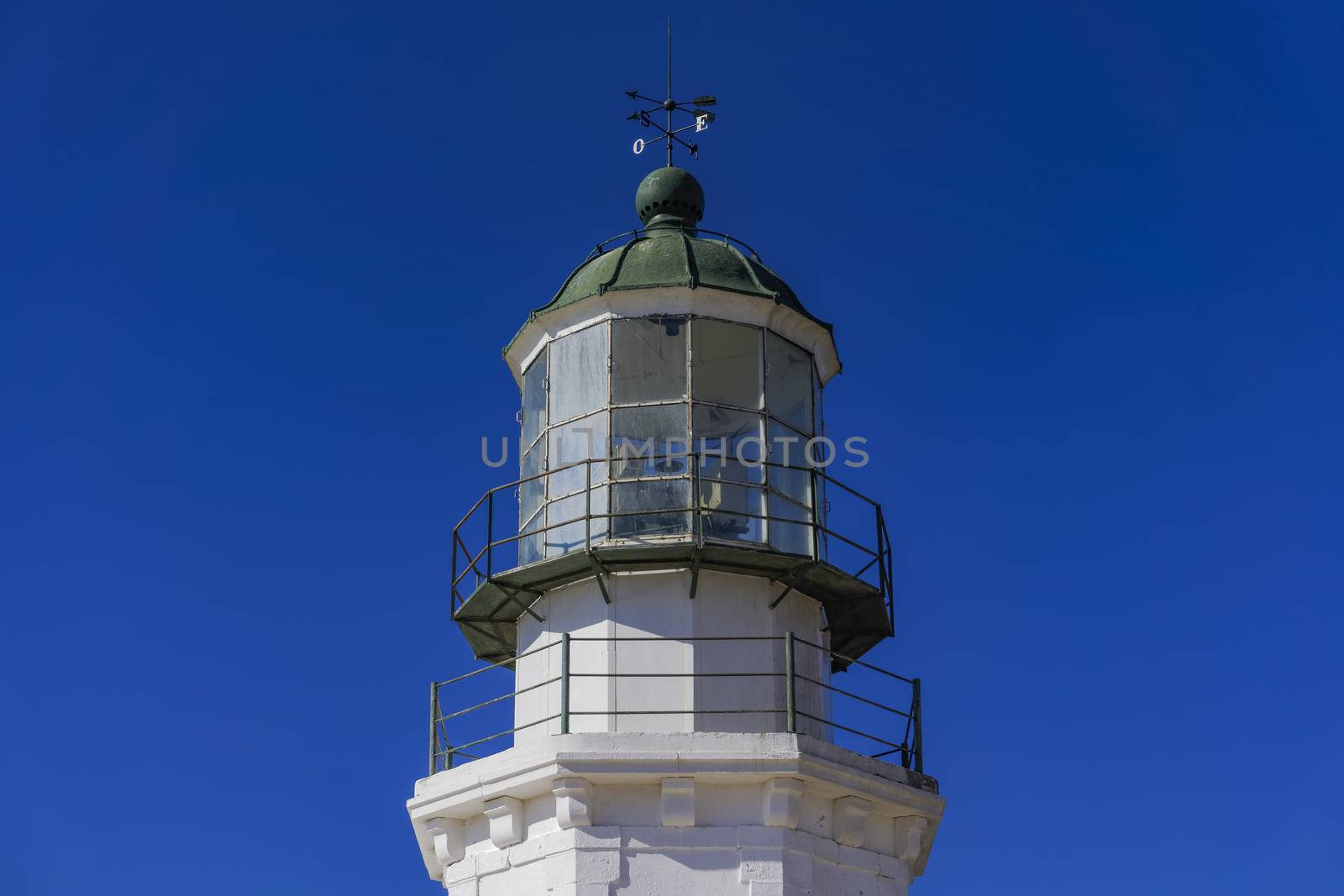 Day view of lighthouse Armenistis manufactured in 1891 on the north-western tip of Mykonos, Greece.