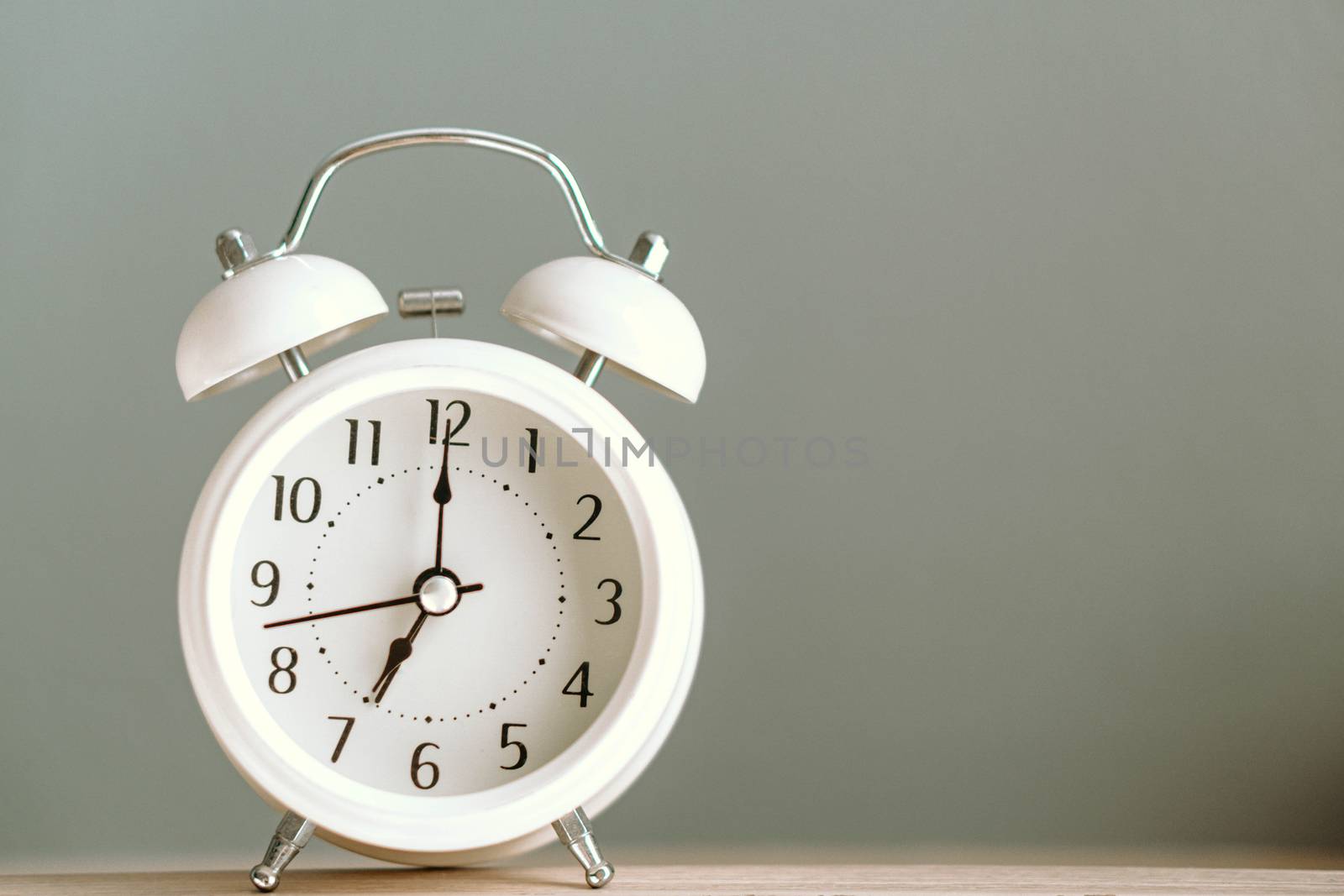 Alarm clock on white table with soft light in the morning, selec by pt.pongsak@gmail.com