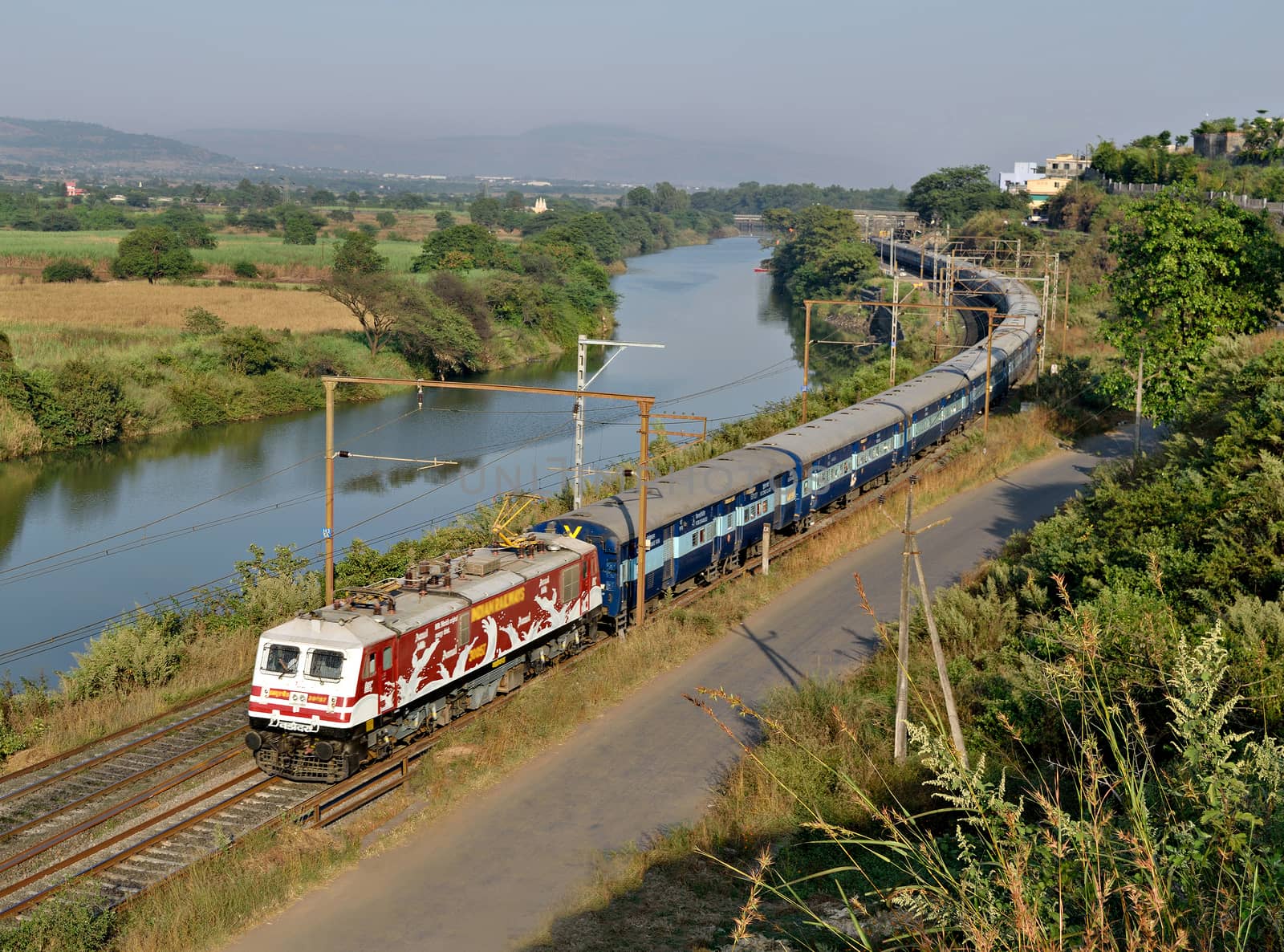 Amul Milk advertised locomotive with Indore express running parallel to a river in through Kamshet, pune, India. by lalam