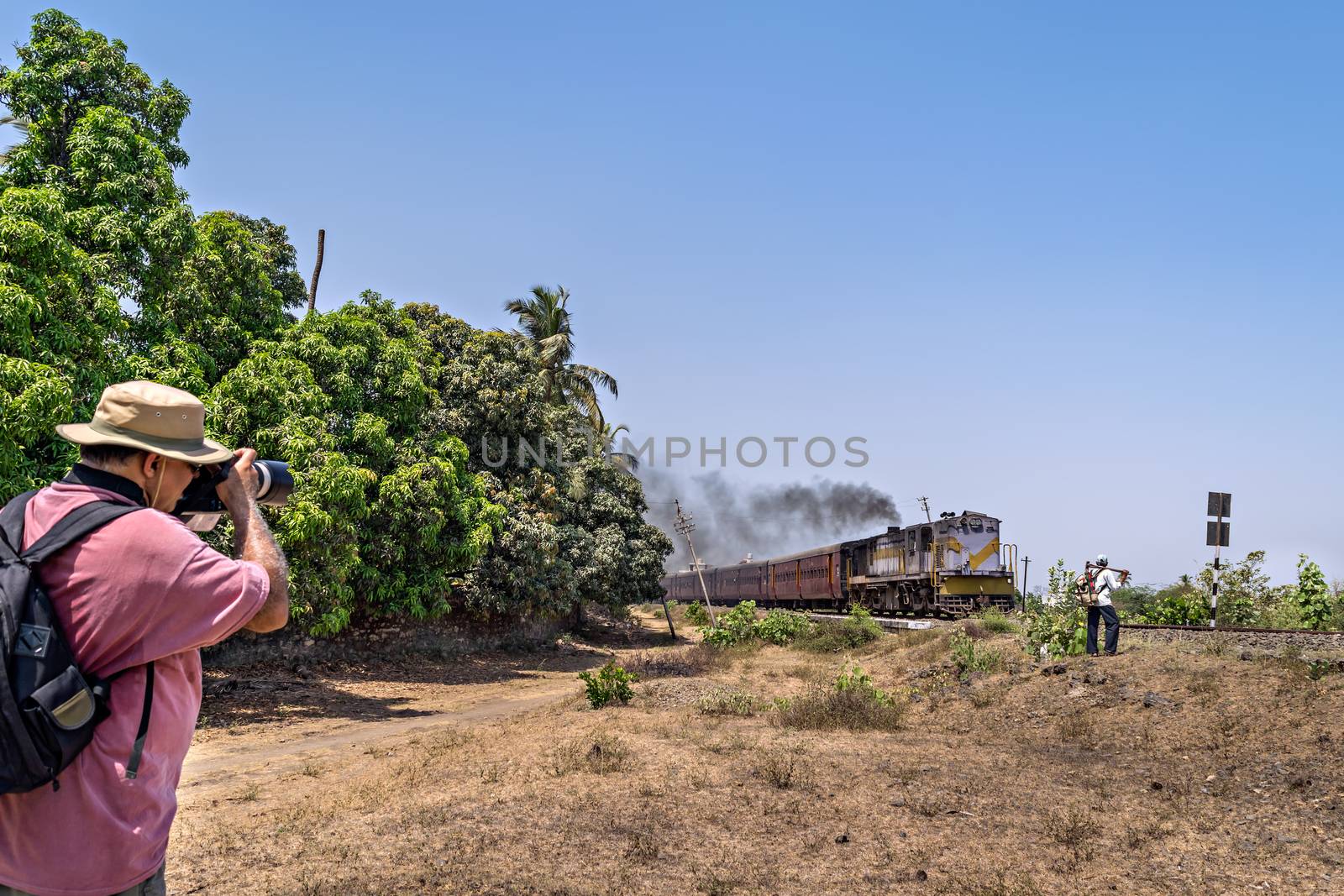 Talala, Gujrat, India - April 17, 2018 : A trainspotter pursuing his hobby of trainspotting.