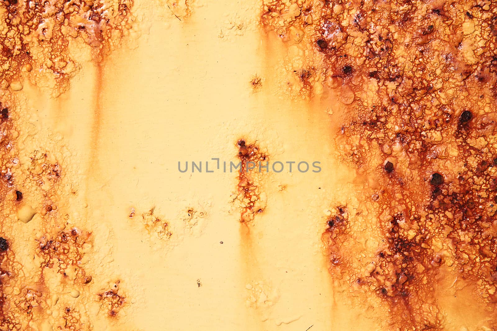 Rust covered weathered iron metal texture background with yellow peeling blistering paint