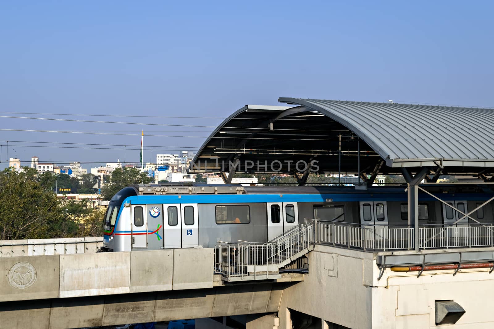 Rapid transit Hyderabad metro train exits Nampally station in the morning. The service has successfully completed one year in 2019, Namapally, Hederabad, India.