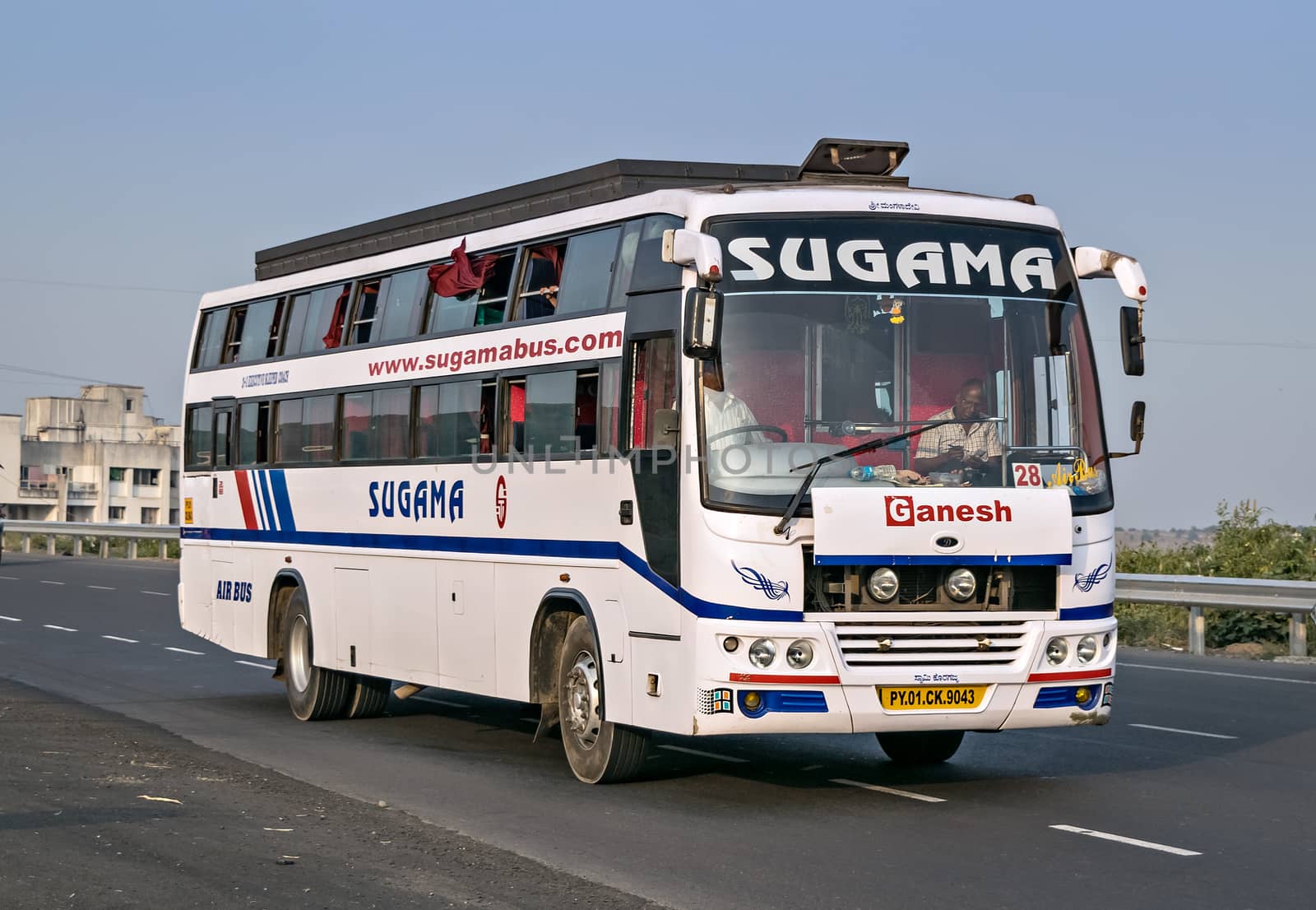 Pune, Maharashtra, India- October 25th, 2016: Sugama travels bus speeding on highway. by lalam