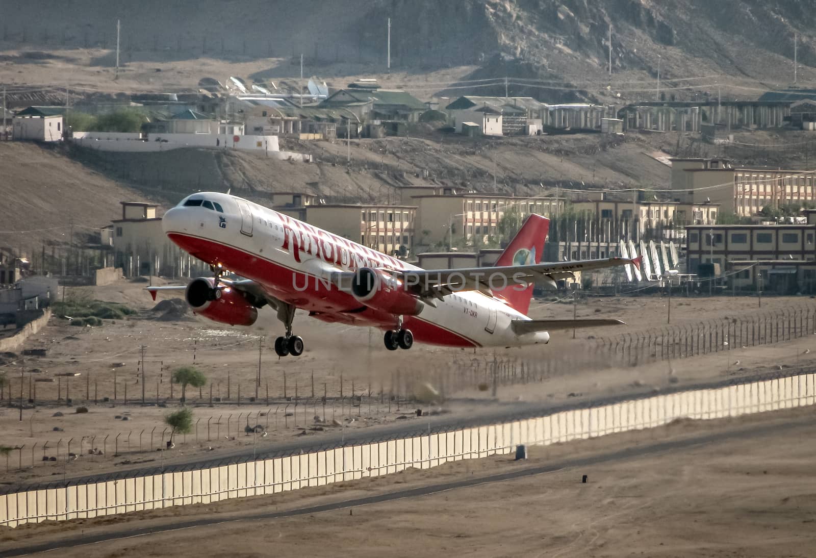 Leh, Jammu and Kashmir, India - June 26, 2011 : Kingfisher Airlines airbus A-320 # VT-DKR takes off from Leh