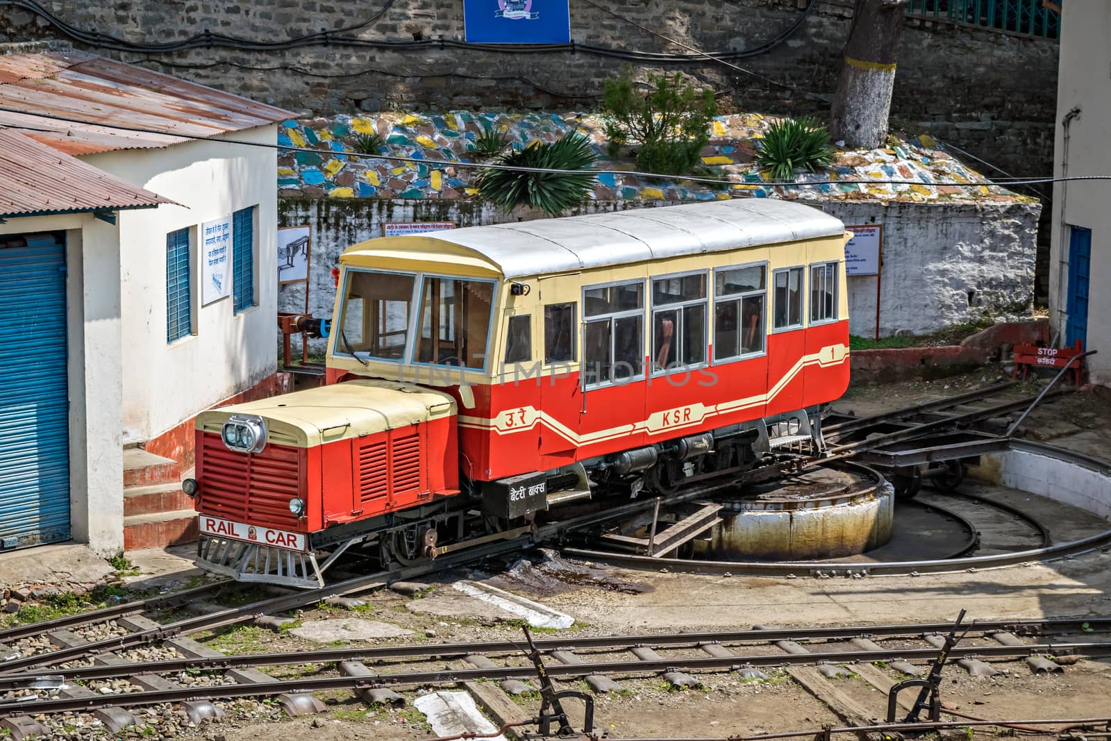 Shimla, Himachal Pradesh, India- April 15th, 2015: Narrow gauge, self propelled, rail car resting on a turn table after its uphill trip from Kalka.