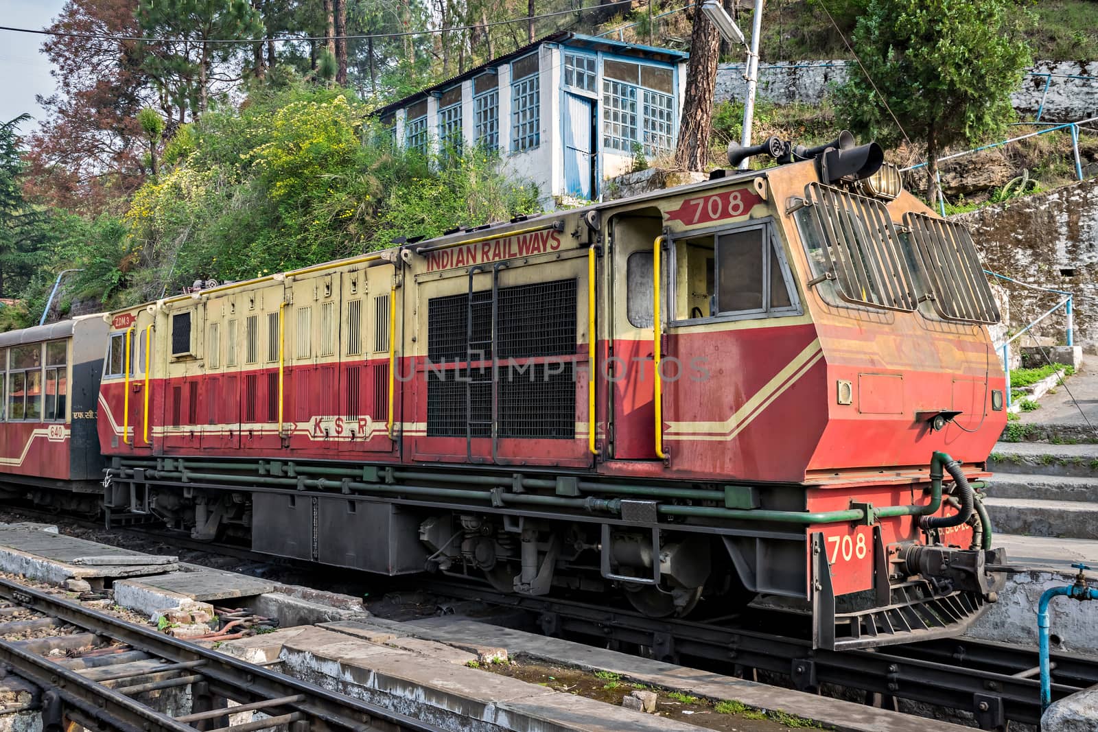 Barog, Himachal Pradesh, India- April 14th, 2015:Narrow gauge locomotive with Kalka-Shimla Shivalik deluxe express, takes a stop a by lalam