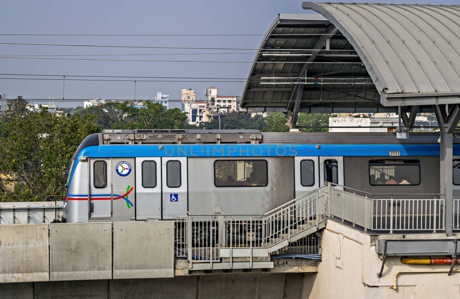 Rapid transit Hyderabad metro train exits Nampally station in the morning. The service has successfully completed one year in 2019, Namapally, Hederabad, India. by lalam