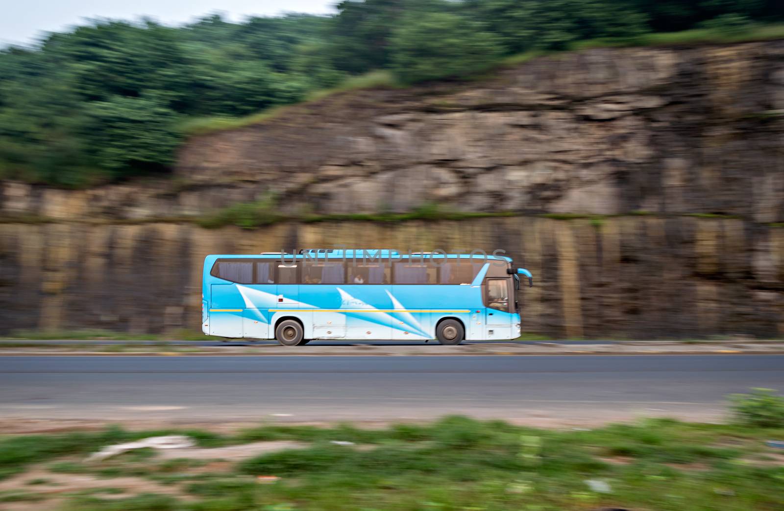 Pan image with blur background of of a speeding MSRTC AC Scania bus , speeding towards Mumbai.