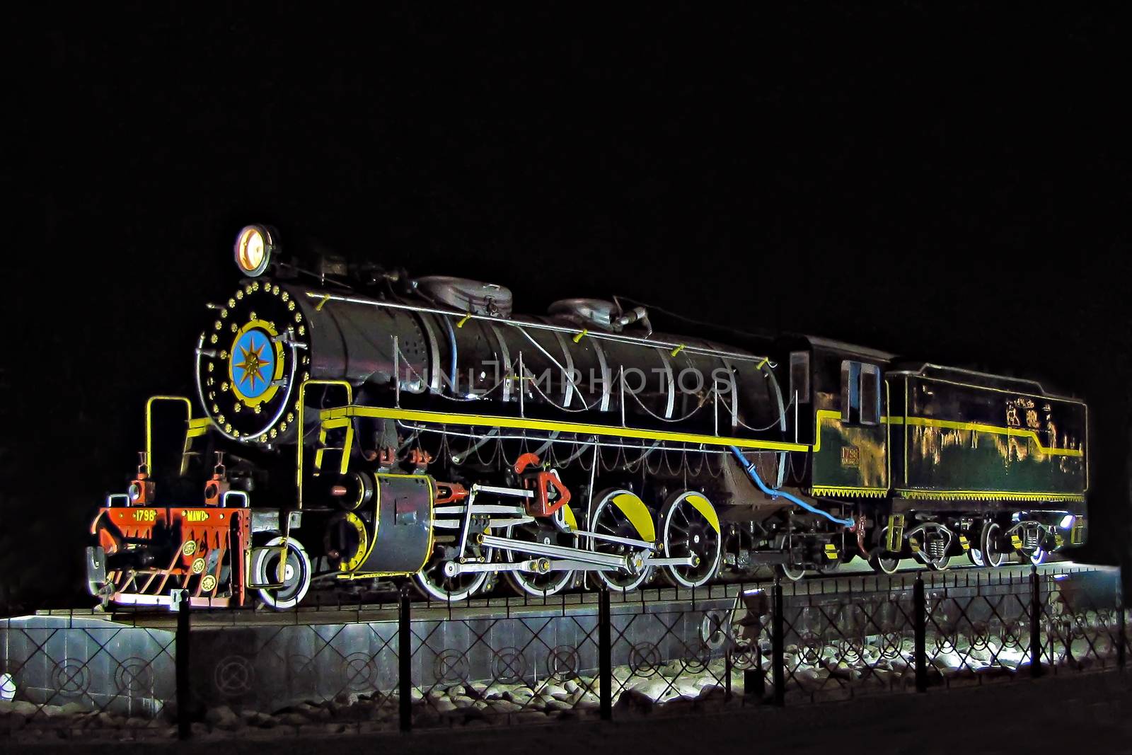 Night image of a steam locomotive plinth-ed in front of New Jalpaiguri station, West Bengal, India. WD class steam locomotive manufactured by Baldwin Loco Works, USA.  It was in the service from 1948 to 1993.