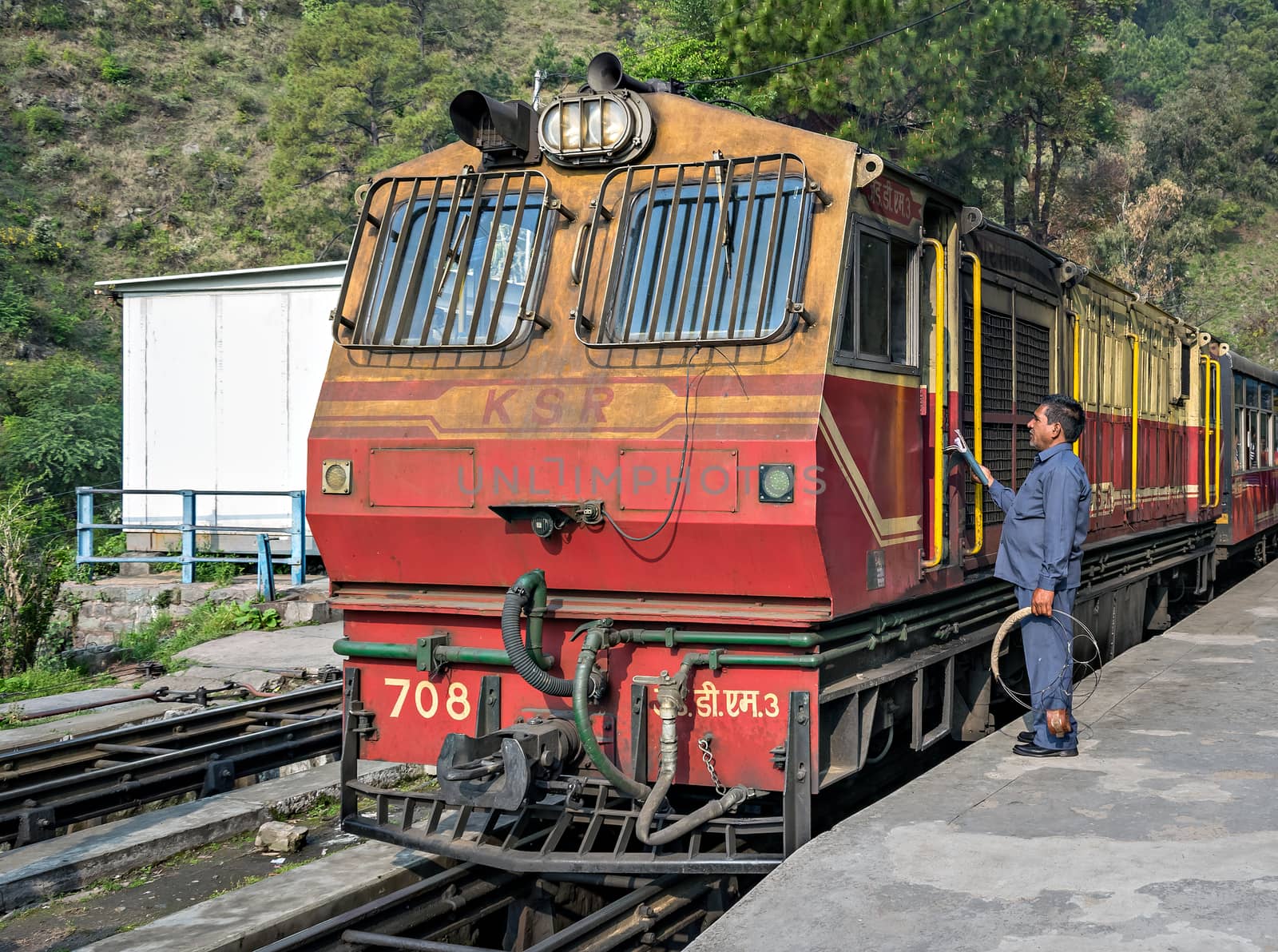 Narrow gauge Kalka to Shimla Shivalik Deluxe express halts at Barog as station staff completes the formalities with crew.