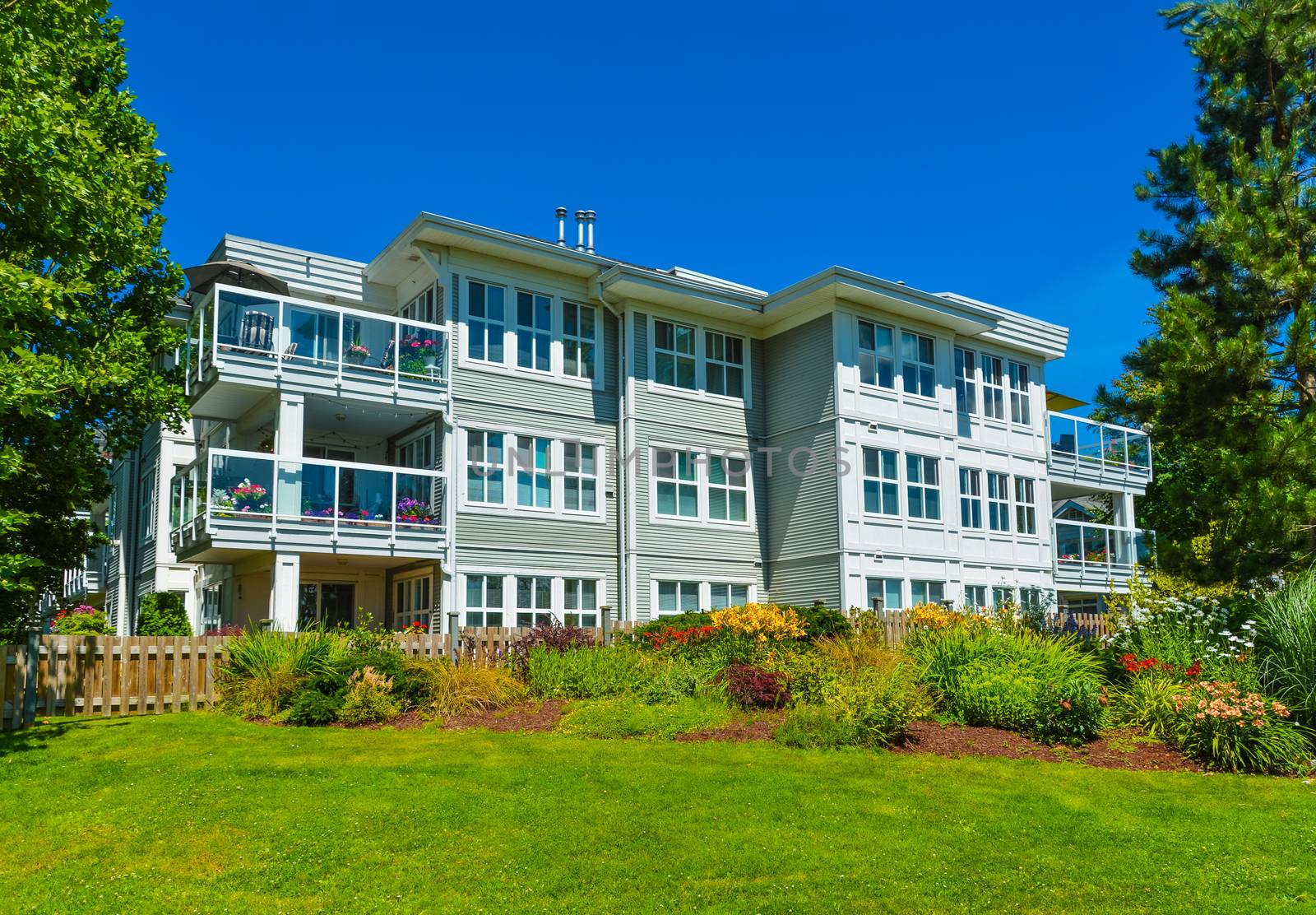 Luxury apartment building with landscaped lawn in front