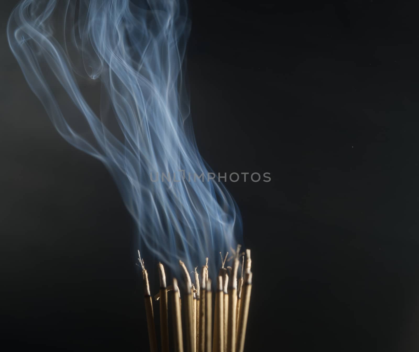 Incense burning incense, white smoke, black background, used as  by noppha80