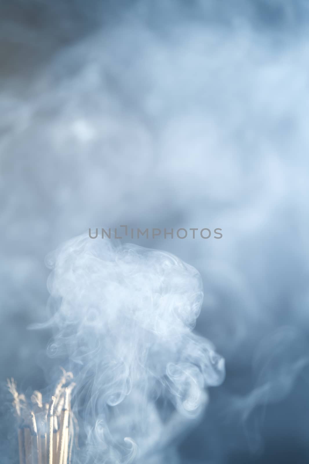 Incense burning incense, white smoke, black background, used as background image Paying homage to the sacred objects of the people of Buddhism according to their beliefs and beliefs.