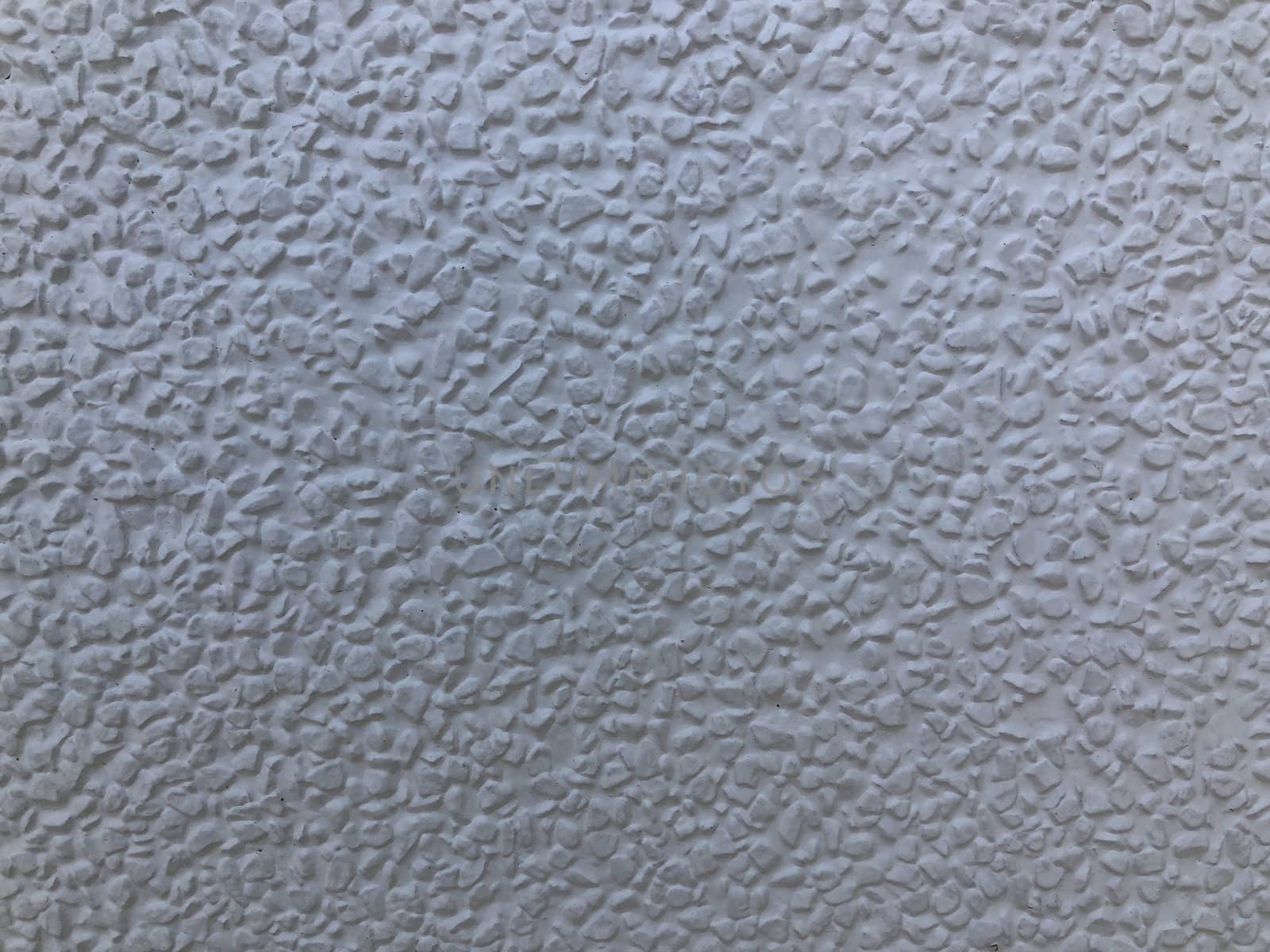 The gray cement background wall has a pattern made of cement plaster.