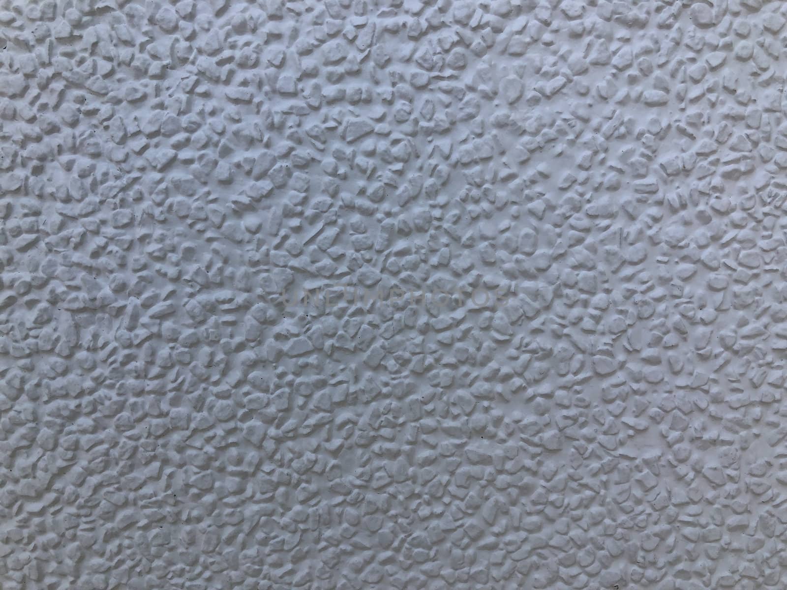 The gray cement background wall has a pattern made of cement plaster.