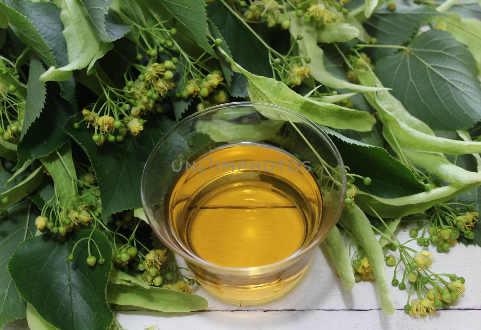 The picture shows a lime blossom tea on white boards