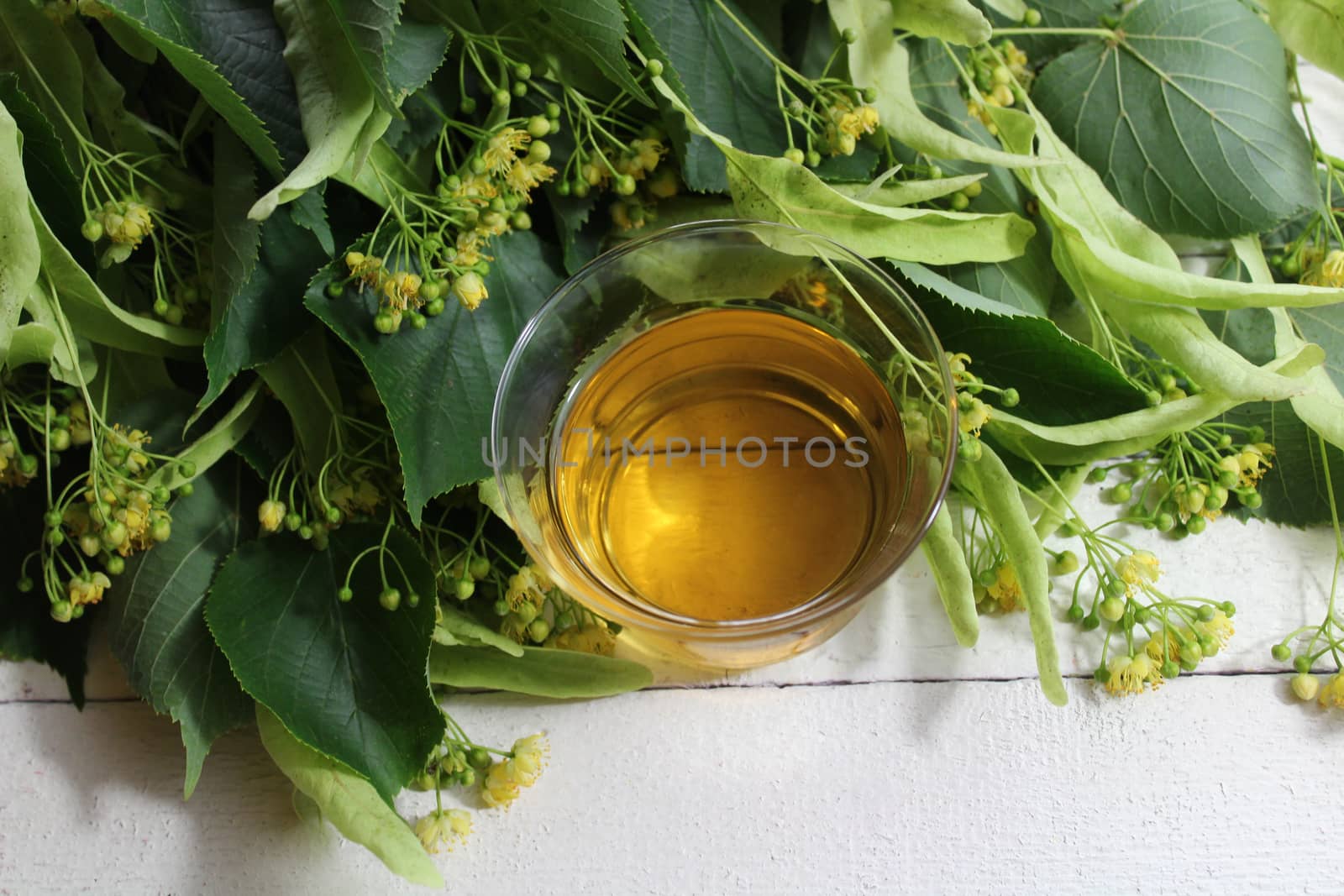 The picture shows lime blossom tea on white boards