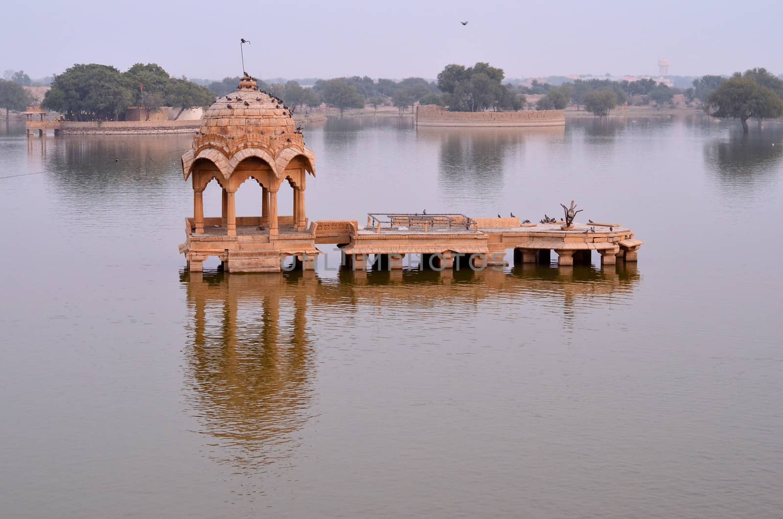Gadisar Lake in Jaisalmer, Rajasthan, India is an artificial lake built by Raja Rawal Jaisal. Gadi sagar lake is surrounded by artistically carved Sandstone Chattri, Temples, Shrines and ghats.