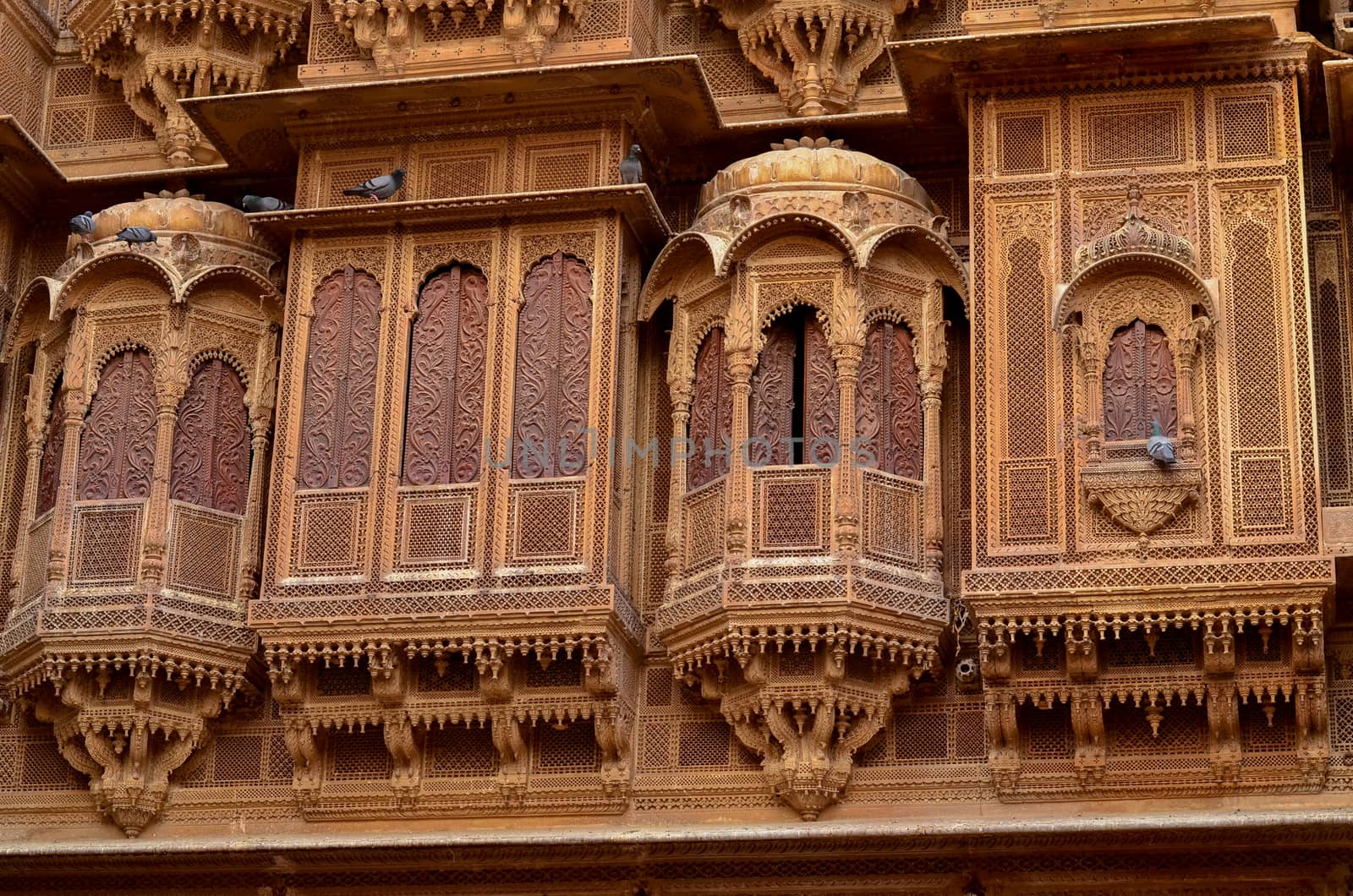 Traditional Rajasthani haveli with a decorated window at Patwon ki haveli in Jaisalmer, Rajasthan, India. Series of early-1800s palaces, now a museum featuring intricate carvings, furniture & artwork. by jayantbahel