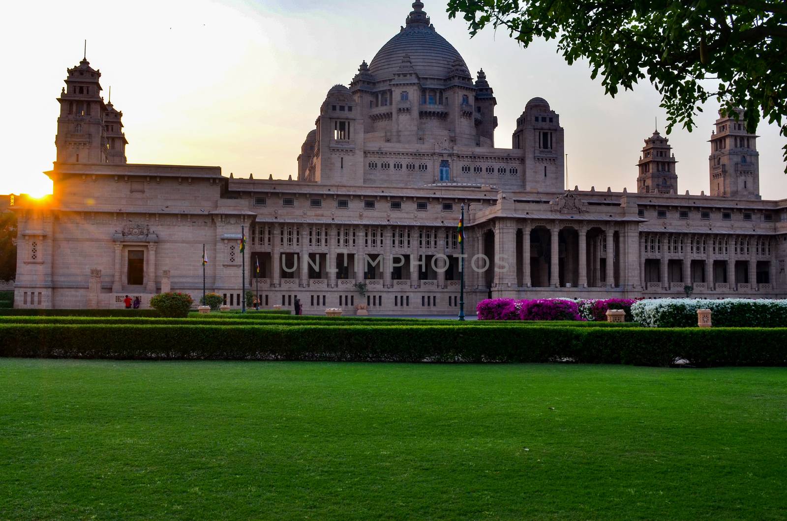 View of the Umaid Bhawan palace and hotel against a setting sun in Jodhpur, Rajasthan, India. This elegant hotel in a grand building was once home to the Jodphur royal family by jayantbahel