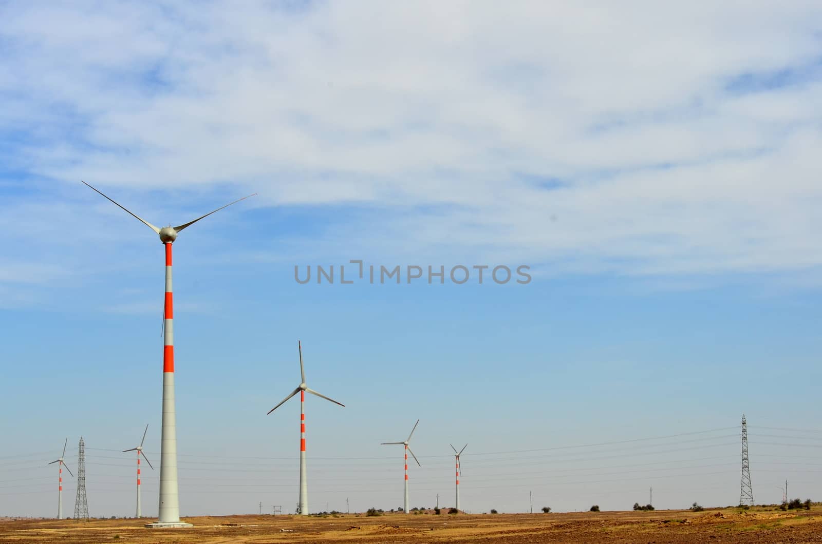 Windmills on the way to Sam Sand Dunes (Thar Desert) from Jaisalmer, Rajasthan, India. The Jaisalmer Wind Park is India's 2nd largest operational onshore wind farm.
